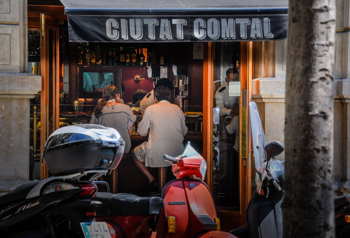 A couple enjoys a meal in an open-door cafe.