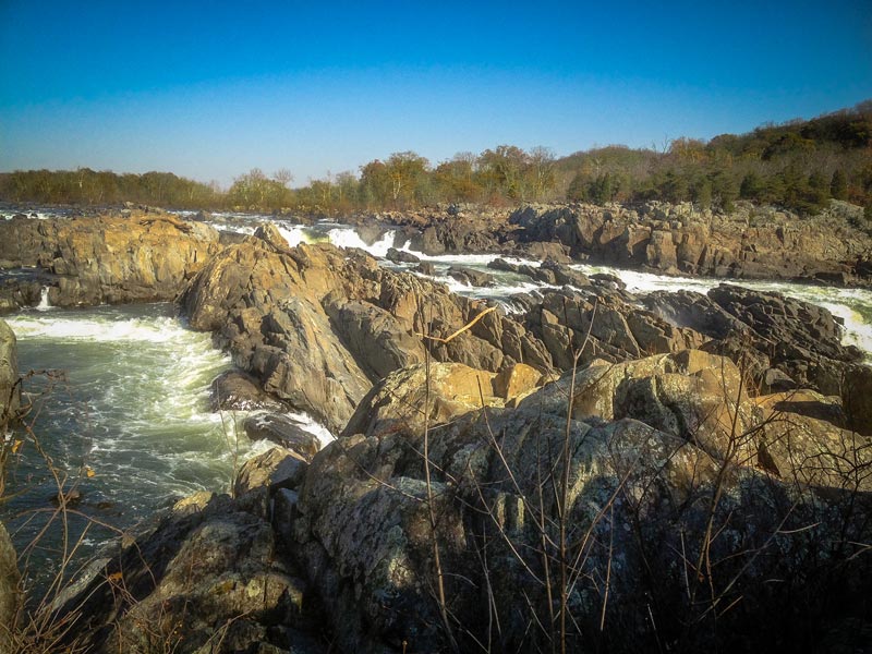 Whitewater rapids carve a path through a treacherous rocky landscape.