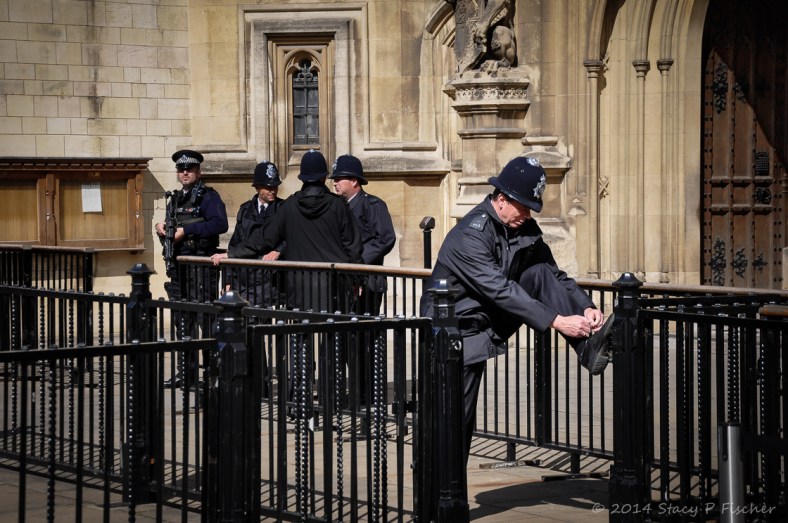 London Bobby Untied; Photo: SPFischer A London Bobby outside the House of Lords props his foot on a railing to tie his shoe.