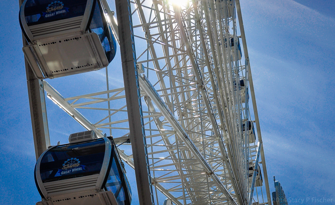 The top half of the Great Wheel, against a bright blue sky.