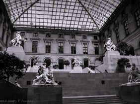 The Cour Marly, topped by a pyramidal glass roof, displays marble statutory.