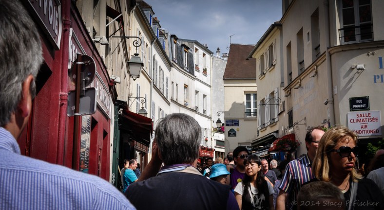 View admidst pedestrians of a busy street in Montmarte