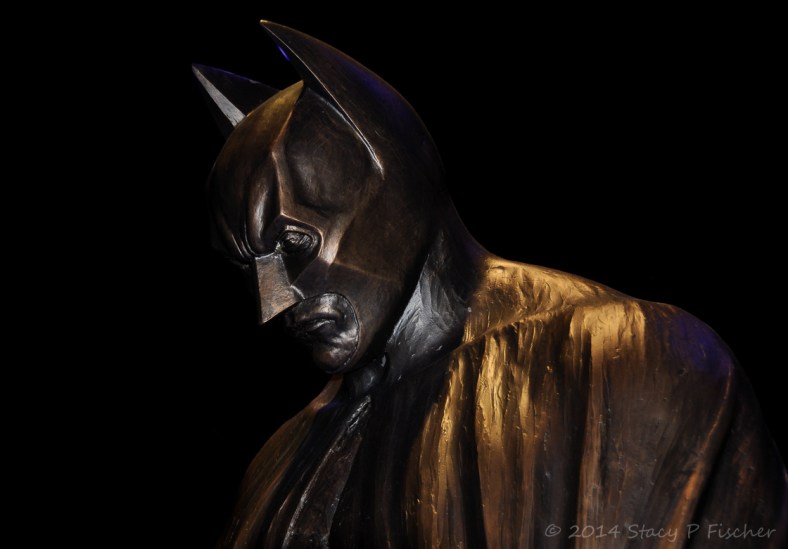 Batman; Photo: SPFischer Partial profile view of the head of the Batman statue, bathed in shadows.