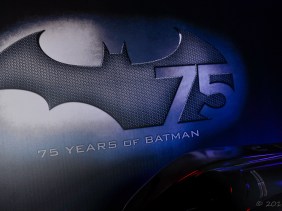 75th Anniversary of Batman logo displayed with classic batmobile in front.