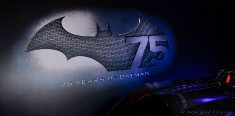 75th Anniversary Logo; Photo: SPFischer 75th Anniversary of Batman logo displayed with classic batmobile in front.