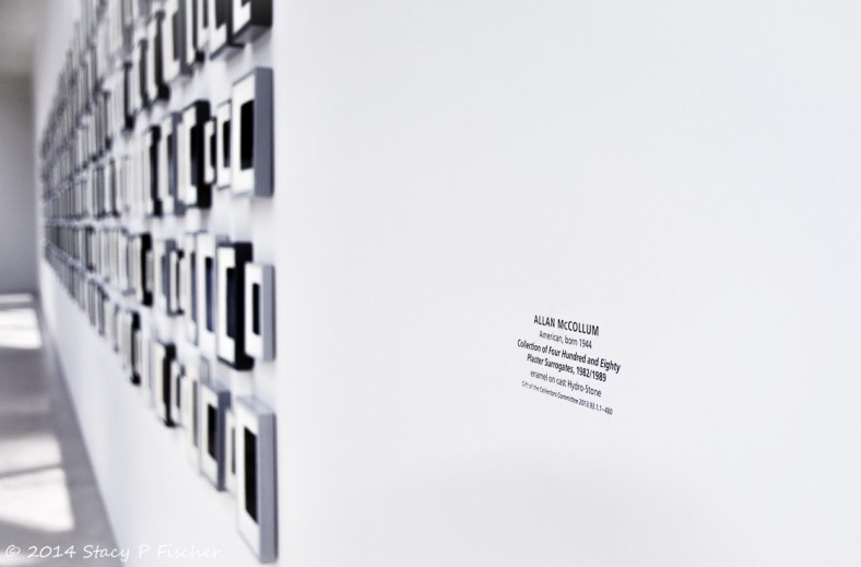 View of McCollum's surrogates from the nameplate down the wall to the exhibit's other end.