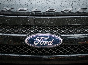 Rainy hood and grill of dark grey Ford Explorer
