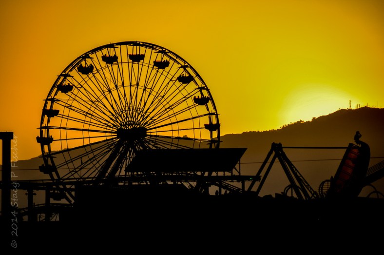 Ferris Wheel; Photo: SPFischer Santa Monica Pier Ferris wheel silhouetted against a sunset of bright orange and yellow.