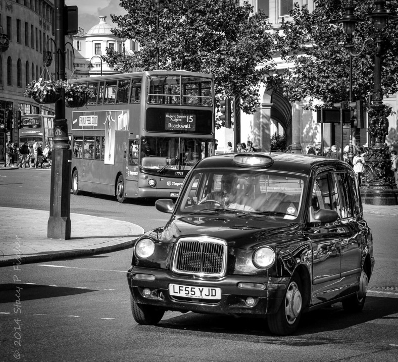 London taxi and London double-decker bus in roundabout.