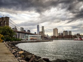 Jane's Carousel in Brooklyn Bridge Park, backdropped by Brooklyn Bridge and One World Trade Center.