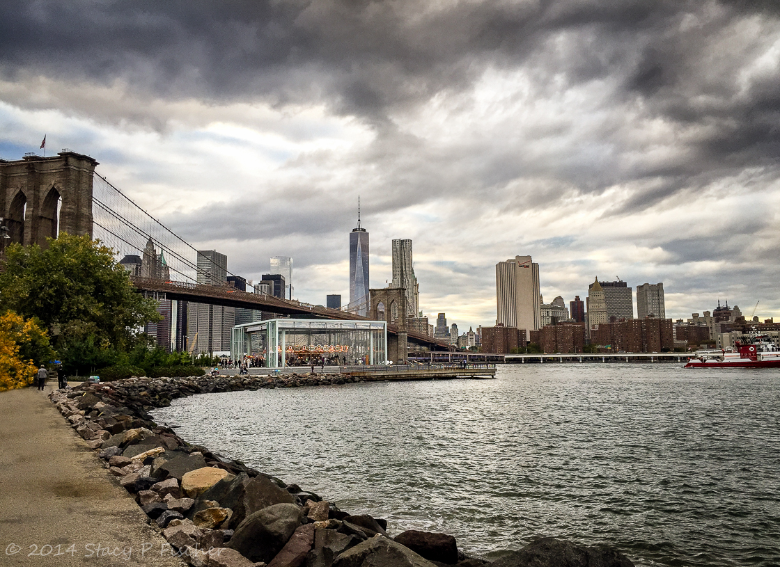 Jane's Carousel in Brooklyn Bridge Park, backdropped by Brooklyn Bridge and One World Trade Center.