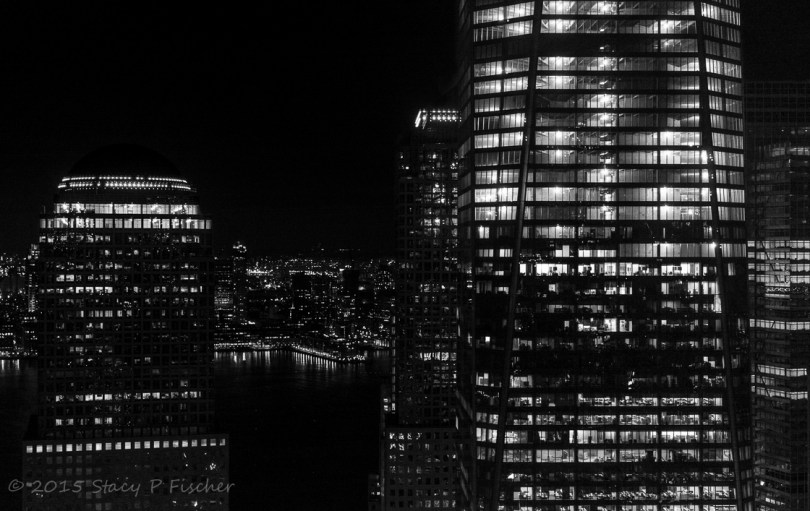 One World Trade Center and surrounding buildings at night.