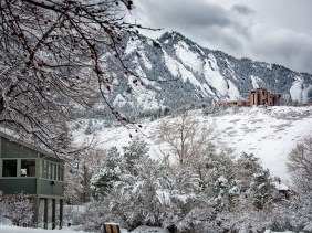 NCAR (National Center for Atmospheric Research) against a backdrop of snow-covered mountains.