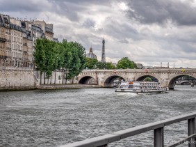 The Seine, a Bateaux Mouches, Pont Neuf, Eiffel Tower, and Institut de Paris.