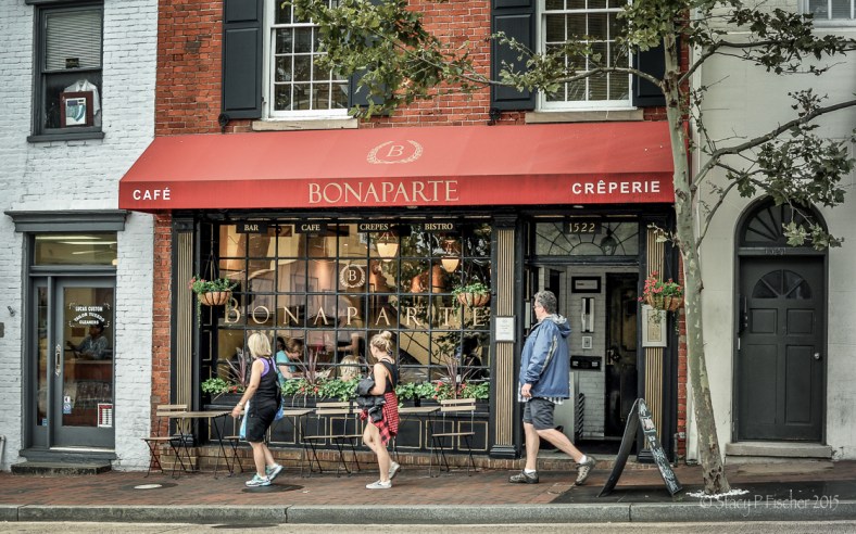 Three pedestrians walk past Cafe Bonaparte, Georgetown, Washington, DC