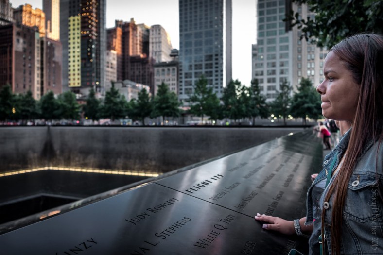 A woman stares out over the 9/11 Memorial South Tower reflecting pool.