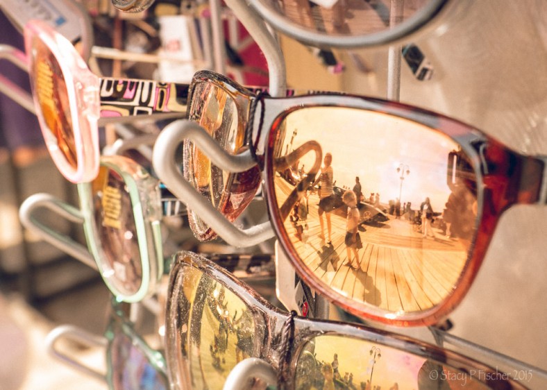 Sunglasses in stand reflecting summer activity on boardwalk, Ocean City, New Jersey