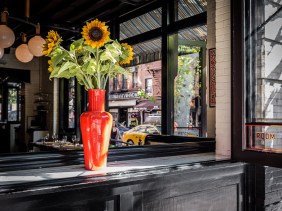 Sunflowers in the open window of "The Dutch" restaurant in New York City South Village