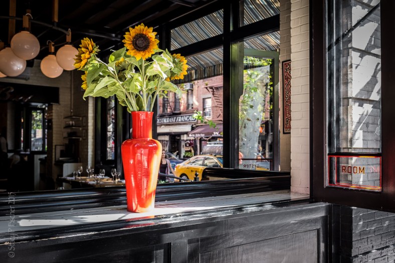 Sunflowers in the open window of "The Dutch" in New York City, South Village