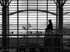 Man silhouetted against windows of Washington National Airport