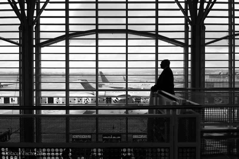 Man silhouetted against windows of Washington National Airport