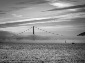 Fog pours over Golden Gate Bridge