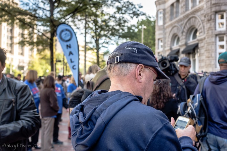 Man wearing "Hillary" baseball hat at Trump International Hotel Washington DC protest