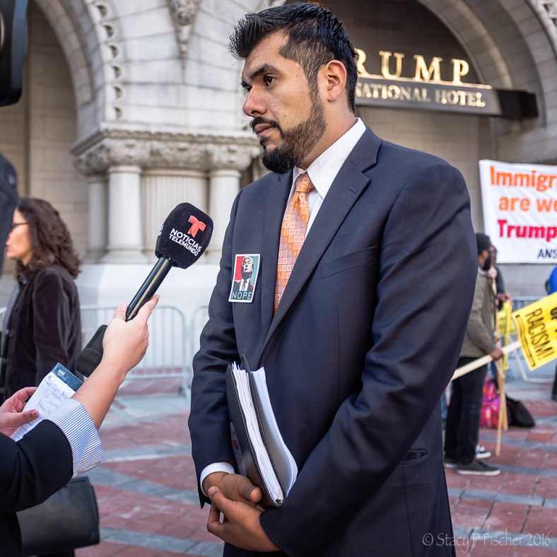 Noticias Telemundo interviewing man wearing "Nope" Trump badge at Trump International Hotel Washington DC