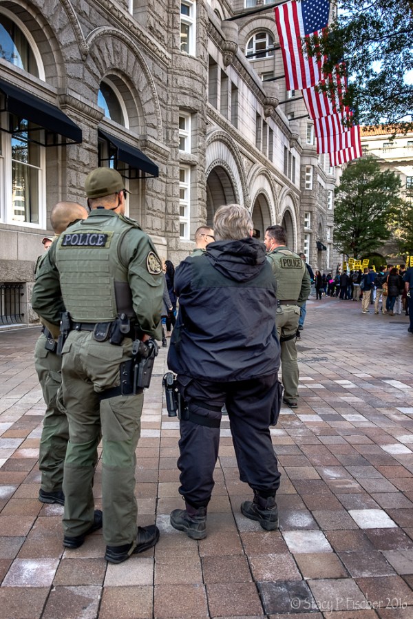 Police and SWAT personnel stand at the ready at Trump Hotel Washington DC protest